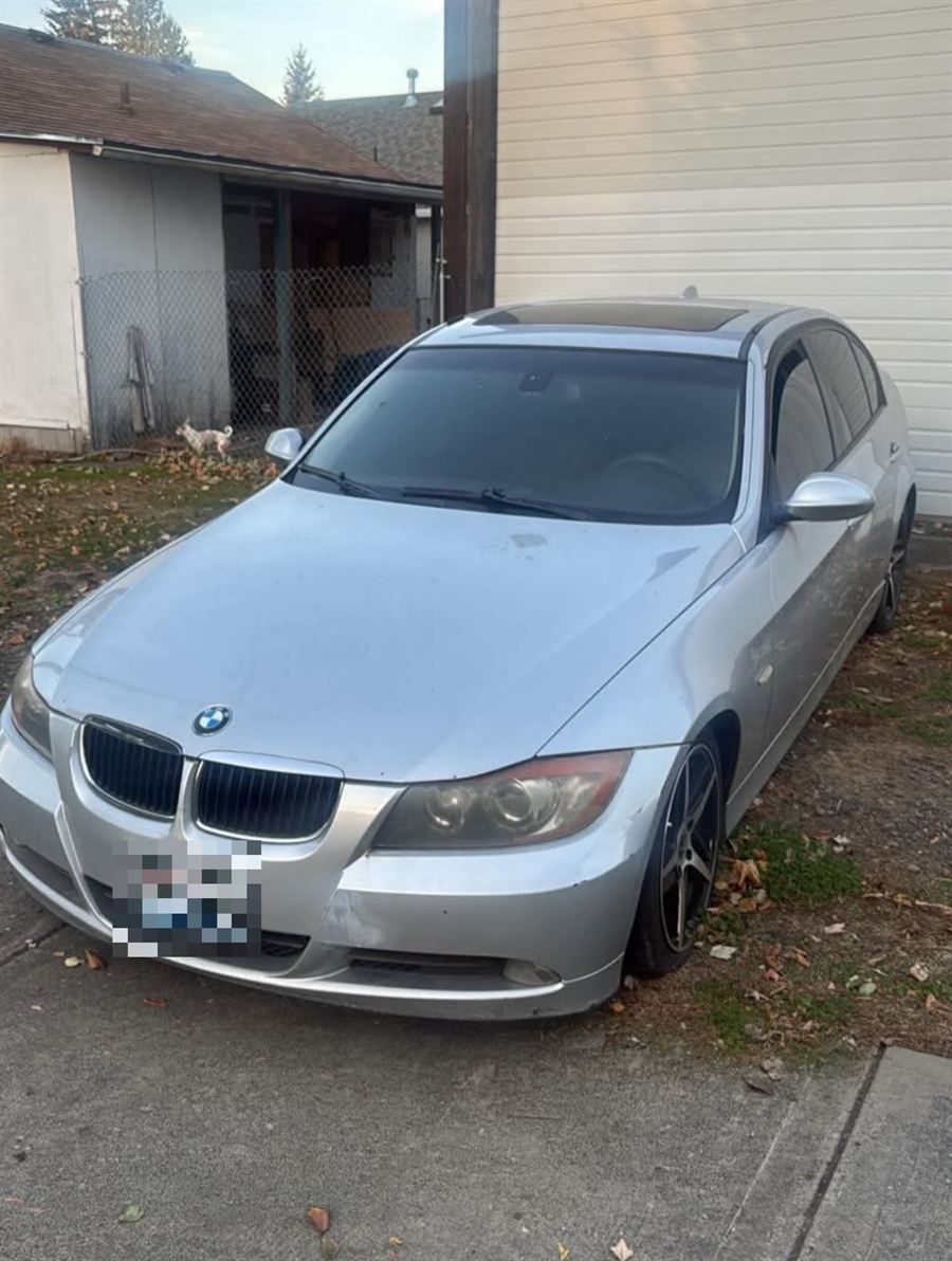 Silver BMW sedan parked in a driveway, ready for pickup